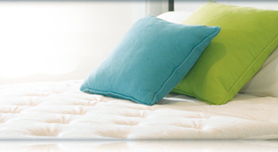 Therapedic mattress with a teal and lime green pillow