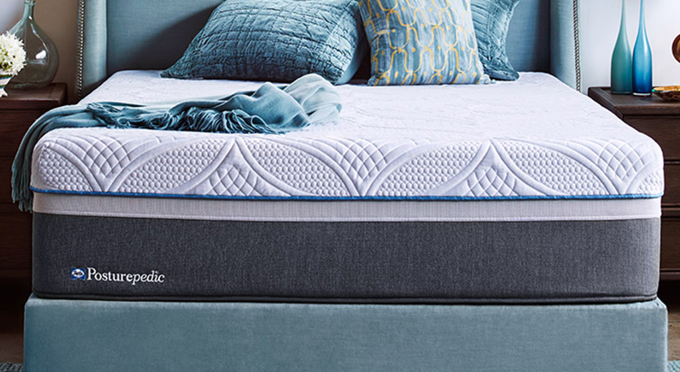 Sealy Posturepedic Hybrid mattress on bed with blue decor